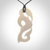 Hand carved bone manaia pendant with paua shell eye inlay. Hand made bone pendant.